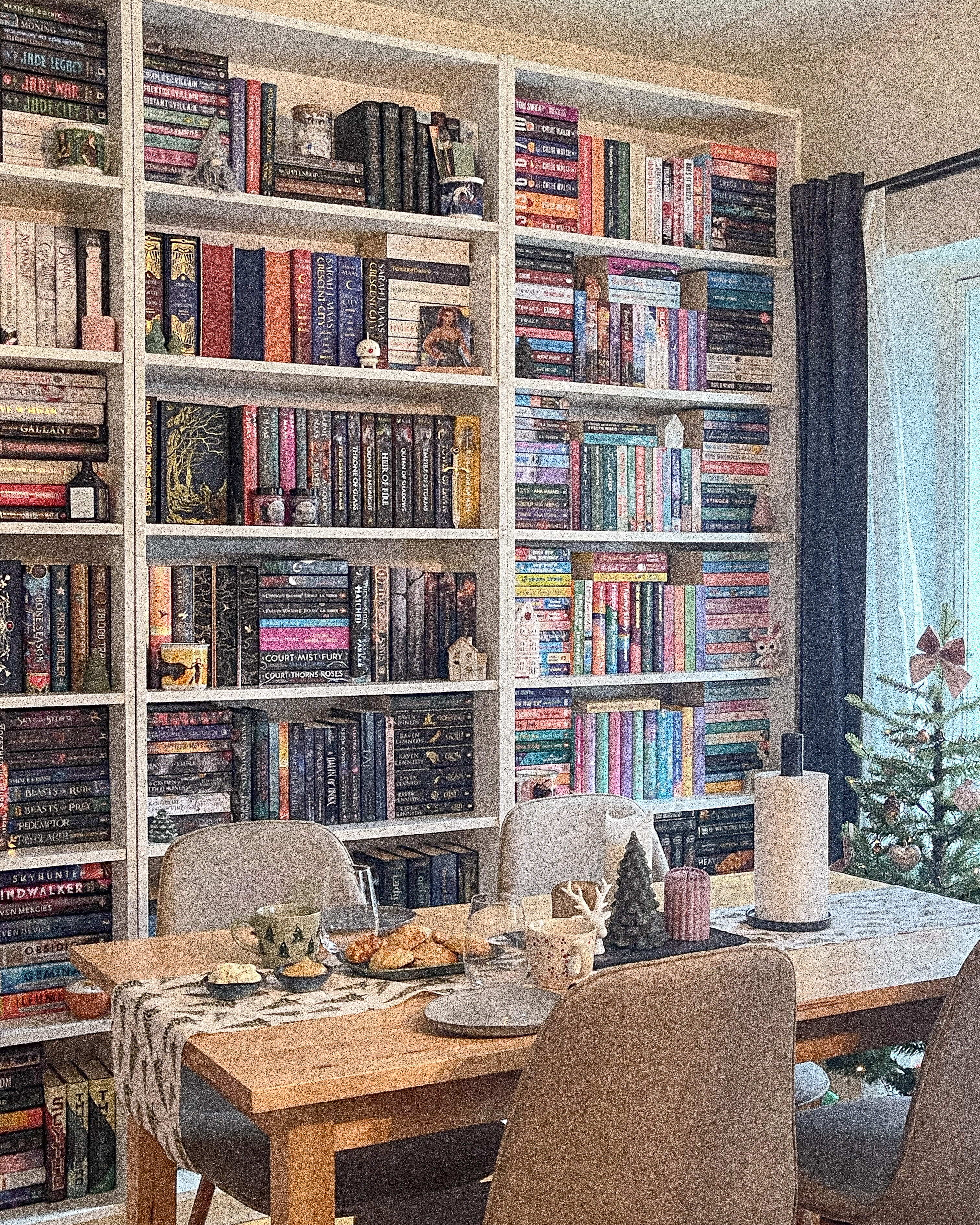 Colorful bookshelves and table set for Christmas hygge